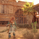 Aloy stands next to a temple in the desert in Horizon Forbidden West on PS5.